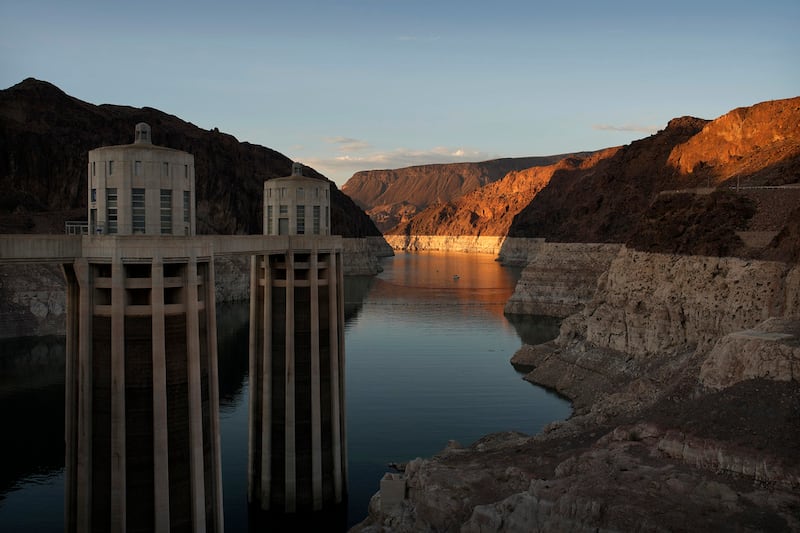 FILE - A bathtub ring of light minerals shows the high water line of Lake Mead near water...